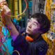 Technician auditing a data cabling system in a server room to identify performance issues.