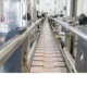 A large logistics warehouse with automated conveyor belts and barcode scanners operating efficiently with structured cabling.