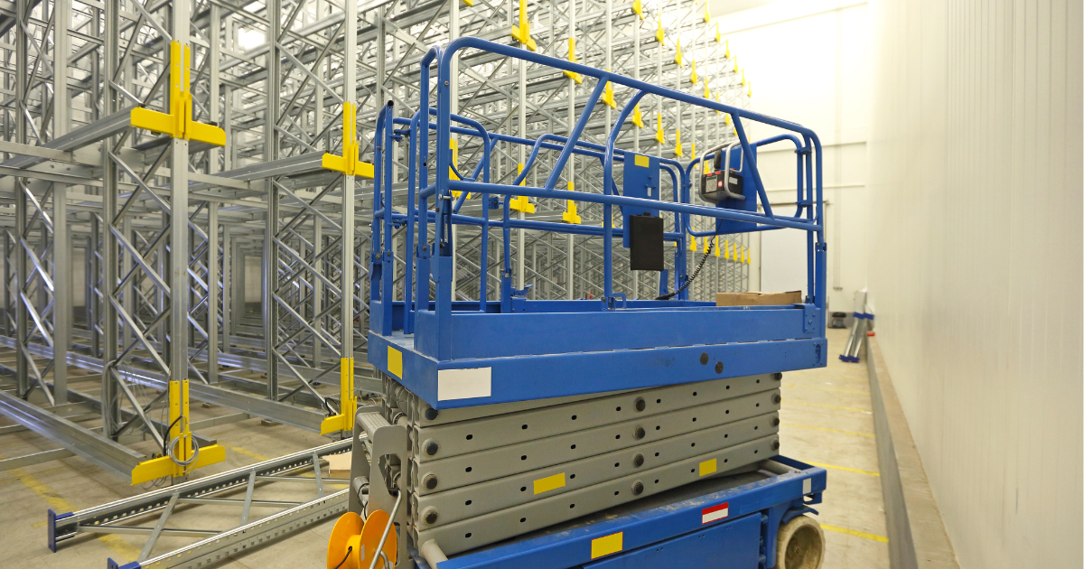 High-level structured cabling being installed in a warehouse using a scissor lift