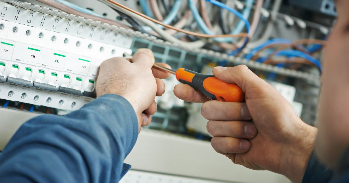 Certified technicians installing network cables in office.