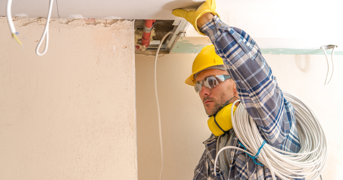 Certified technician installing structured cabling in office