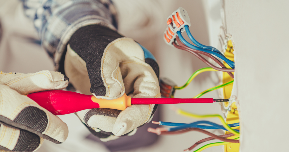 Certified data cabling installer fitting Cat6a cabling in a business network rack