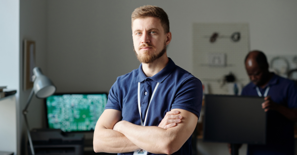 Technician completing data cabling installation projects in a UK business network cabinet.