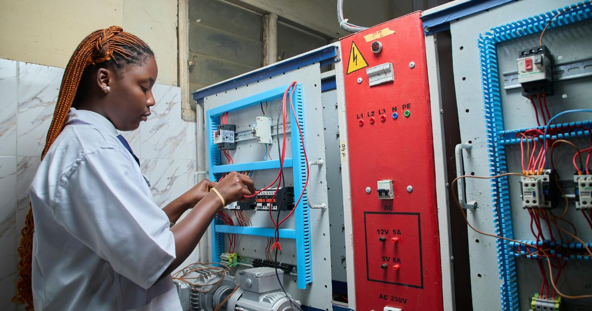 Technician completing a Cat6 cabling installation for a new electric car dealership.