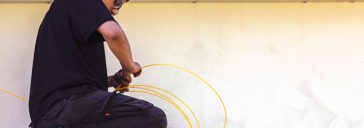 Engineers installing commercial data cabling in a UK office building.